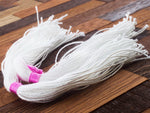White cotton strings that come with white, cream and shimmered gold variant.